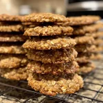 ['A close-up side view of thick and chewy chai oatmeal cookies topped with a maple glaze.', 'Juicy chai oatmeal cookies featuring a glossy maple glaze, captured in detail.', 'Side view of a stack of chai oatmeal cookies with a shiny maple icing, showcasing their texture.', 'Close view of chai oatmeal cookies with a rich maple glaze, highlighting their chewy appearance.']