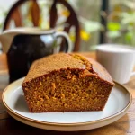 ['Close-up of a slice of pumpkin chai latte bread with a golden crust and soft texture.', 'Side view of a moist pumpkin chai latte bread, showcasing its rich color and spices.', 'A delicious slice of pumpkin chai latte bread with a hint of chai tea, displaying its ingredients.', 'Juicy pumpkin chai latte bread slice on a wooden board, highlighting its inviting appearance.']