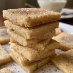 ['Close-up view of a stack of Vanilla Chai Shortbread Cookies, showcasing their golden-brown edges.', 'Side view of Vanilla Chai Shortbread Cookies with a dusting of powdered sugar, highlighting their texture.', 'A delicious arrangement of Vanilla Chai Shortbread Cookies, featuring a sprinkle of cinnamon on top.', 'Detailed shot of Vanilla Chai Shortbread Cookies, emphasizing their crumbly texture and warm spices.']