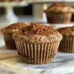 ['Close-up view of moist Vegan Chai Muffins with a golden-brown top, showcasing spices.', 'Side view of Vegan Chai Muffins, highlighting their fluffy texture and warm color.', 'Deliciously baked Vegan Chai Muffins, featuring visible cinnamon and spice flecks.', 'A tantalizing image of Vegan Chai Muffins with a crisp exterior and soft interior.']